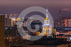 Tower in architecture Stalinist empire with star illuminated by colored lights at night. Voronezh, Russia