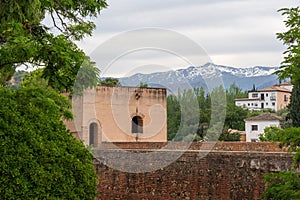 Tower of Baltasar de la Cruz at Alhambra with Sierra Nevada Mountains - Granada, Andalusia, Spain photo
