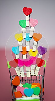 Tower Beauty Colorful mini hearts with other color blur pink and white background and copy space in the mini shopping cart