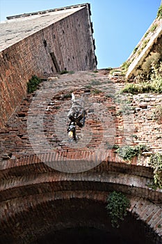 Tower in the blue sky, seen from one of the entrance doors, of Castelvecchio in Verona.