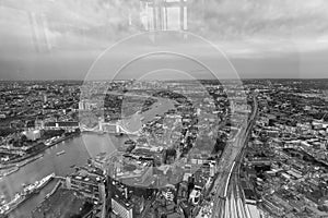 Tower Bridge and city skyline along river Thames at night, aerial view - London - UK