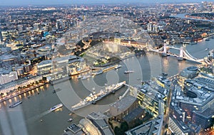 Tower Bridge and city skyline along river Thames at night, aerial view - London - UK