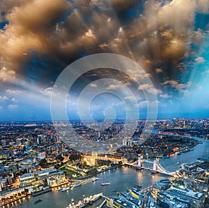 Tower Bridge and city skyline along river Thames at night, aerial view - London - UK