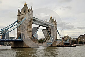 Tower Bridge is a combined bascule and suspension bridge in London that crosses Thames river photo