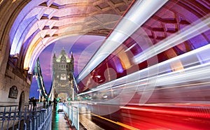 Tower Bridge in London with blurred red bus passing by