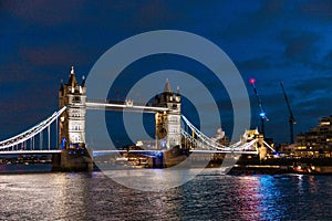 tower bridge in london at night, cloudy daytime