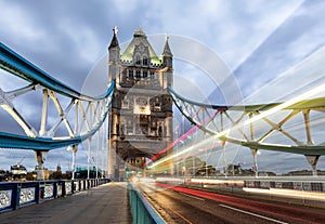 Tower Bridge in London with passing by red bus