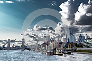 Tower Bridge And River Thames With Ships And Boats In Front Of Modern Office Buildings In The City Of London, United Kingdom photo