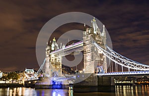 Tower Bridge seen from the docks at night in London, UK