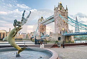Tower Bridge at sunset with fountain and city skyline - London,