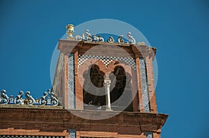 Tower on building facade with ceramics and bricks details at Merida