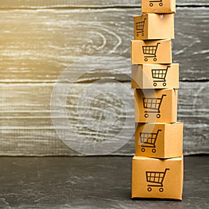 Tower of cardboard boxes with pattern of shopping carts. Purchasing power, delivery order. E-commerce, logistics, distribution.