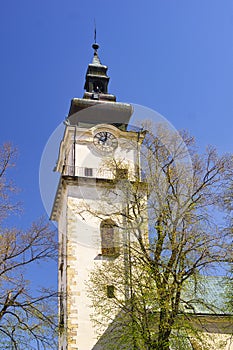 The tower of The Church of the Assumption of the Virgin Mary in Lubica with fortication wall