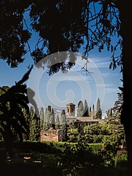 Tower of the church Iglesia de Santa Maria de la Encarnacion in the Alhambra, Granada, from the gardens of Generalife