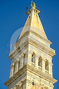 The Tower of The Church of St. Euphemia on the background of blue sky in Rovinj, Croatia