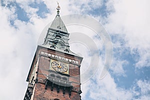 Tower with clock in the city hall in Copenhagen against the blue