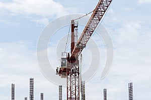 Tower construction crane in building construction site with blue sky background