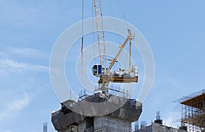 Tower construction crane in rooftop building construction site