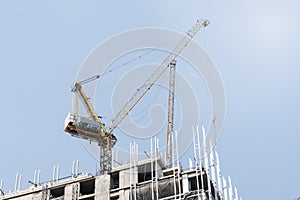 Tower construction crane in rooftop building construction site