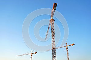 tower crane against blue sky. Image from below.