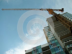 Tower crane attached to concrete building during construction.