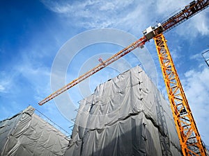 Tower crane in building construction site low angle view