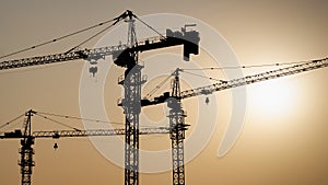 Tower crane at building construction site silhouette