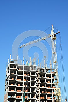 Tower Crane and Building Constructors on Construction Site. Building with two cranes on construction site with builders.