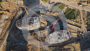 Tower crane during construction of a residential building. Cranes on formworks. Arial view of the construction the multi-storey