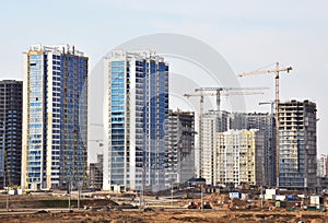 Tower crane on construction of a residential building. Cranes on formworks. Construction the building or multi-storey homes.