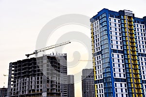 Tower crane on construction of a residential building. Cranes on formworks. Construction the building or multi-storey homes.