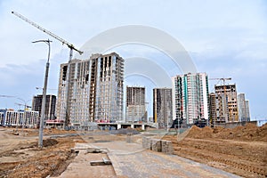 Tower crane on construction of a residential building. Cranes on formworks. Construction the building or multi-storey homes.