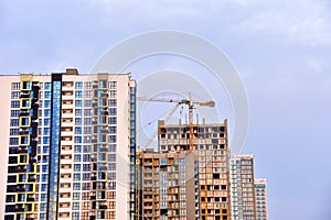 Tower crane on construction of a residential building. Cranes on formworks. Construction the building or multi-storey homes.