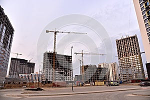 Tower crane on construction of a residential building. Cranes on formworks. Construction the building or multi-storey homes.