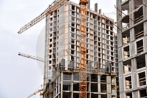 Tower crane on construction of a residential building. Cranes on formworks. Construction the building or multi-storey homes.