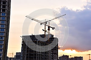 Tower crane on construction of a residential building. Cranes on formworks. Construction the building or multi-storey homes.