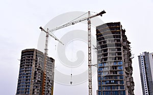 Tower crane on construction of a residential building. Cranes on formworks. Construction the building or multi-storey homes.