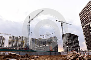 Tower crane on construction of a residential building. Cranes on formworks. Construction the building or multi-storey homes.