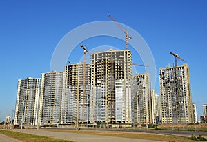 Tower crane on construction of a residential building. Cranes on formworks. Construction the building or multi-storey homes.