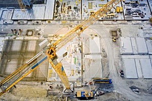 Tower crane at construction site with base plate made of steel and concrete