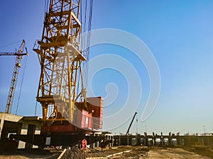 tower crane at the construction site begins construction of a monolithic frame house after pouring the concrete