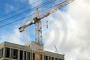 Tower crane on construction site on blue sky