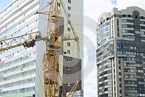 Tower crane on a construction site for lift a load at high-rise building.