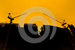 Tower crane on a construction site at sunrise