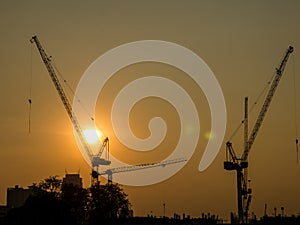 Tower crane on a construction site at sunrise