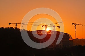 Tower crane on a construction site at sunset