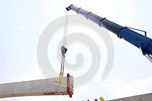 Tower crane with guideway beam on blue sky as a background in the construction site