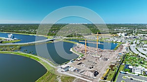 Tower crane at industrial construction site. View from above of new developing residense in american city suburbs