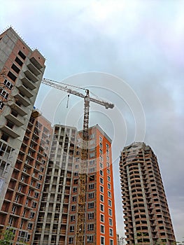 A tower crane near several high-rise buildings under construction