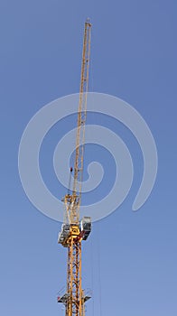 Tower crane soars into blue sky